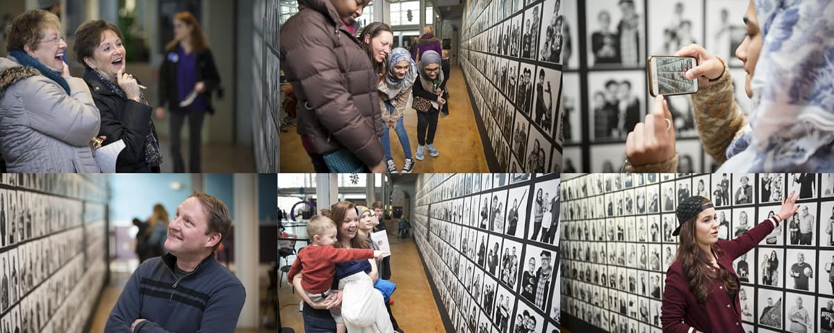 People captivate by the community portrait wall